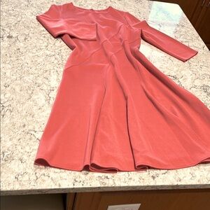 St John knee length knit, coral color,  flattering A line swing style skirt.